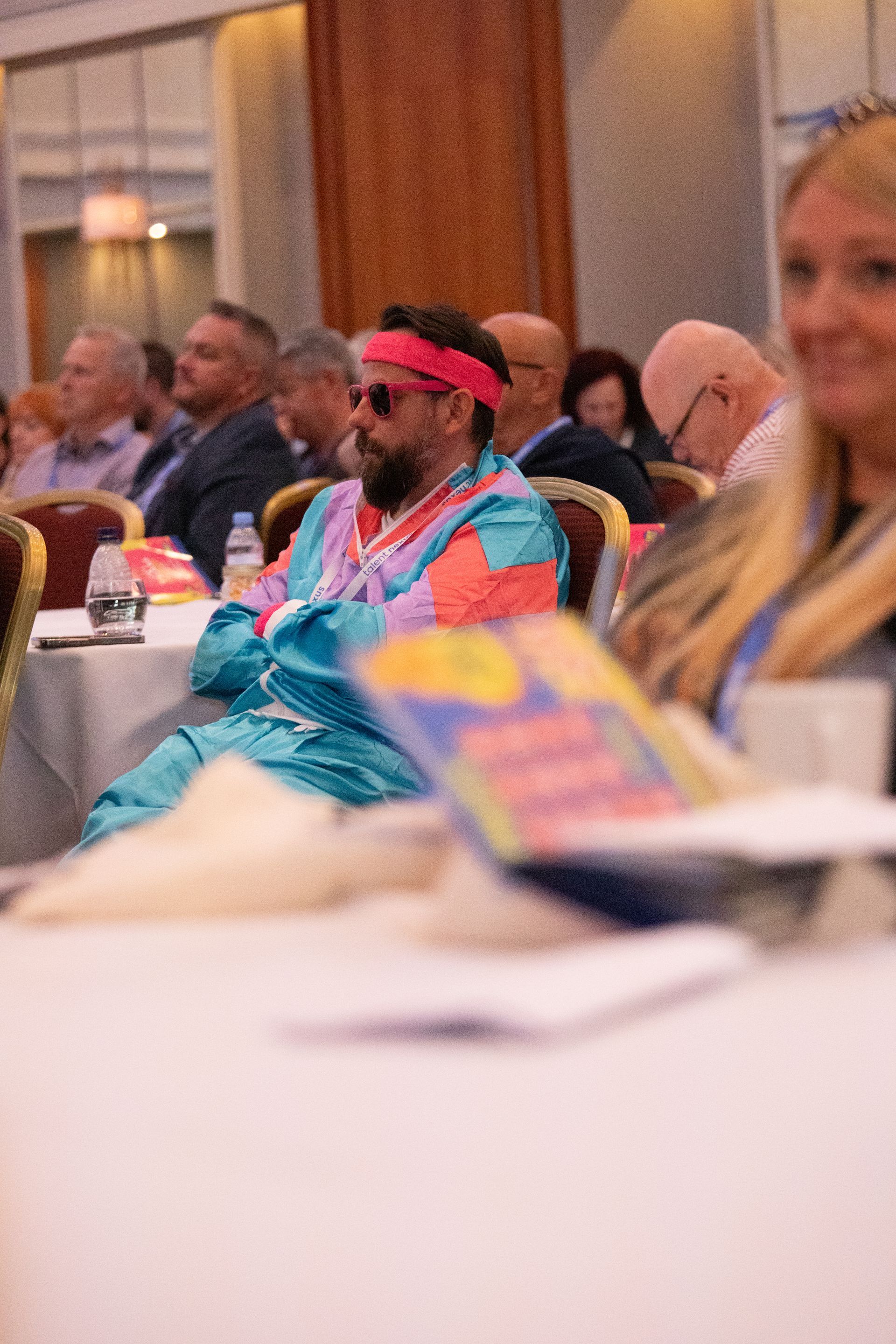 A group of people are sitting at tables in a room.