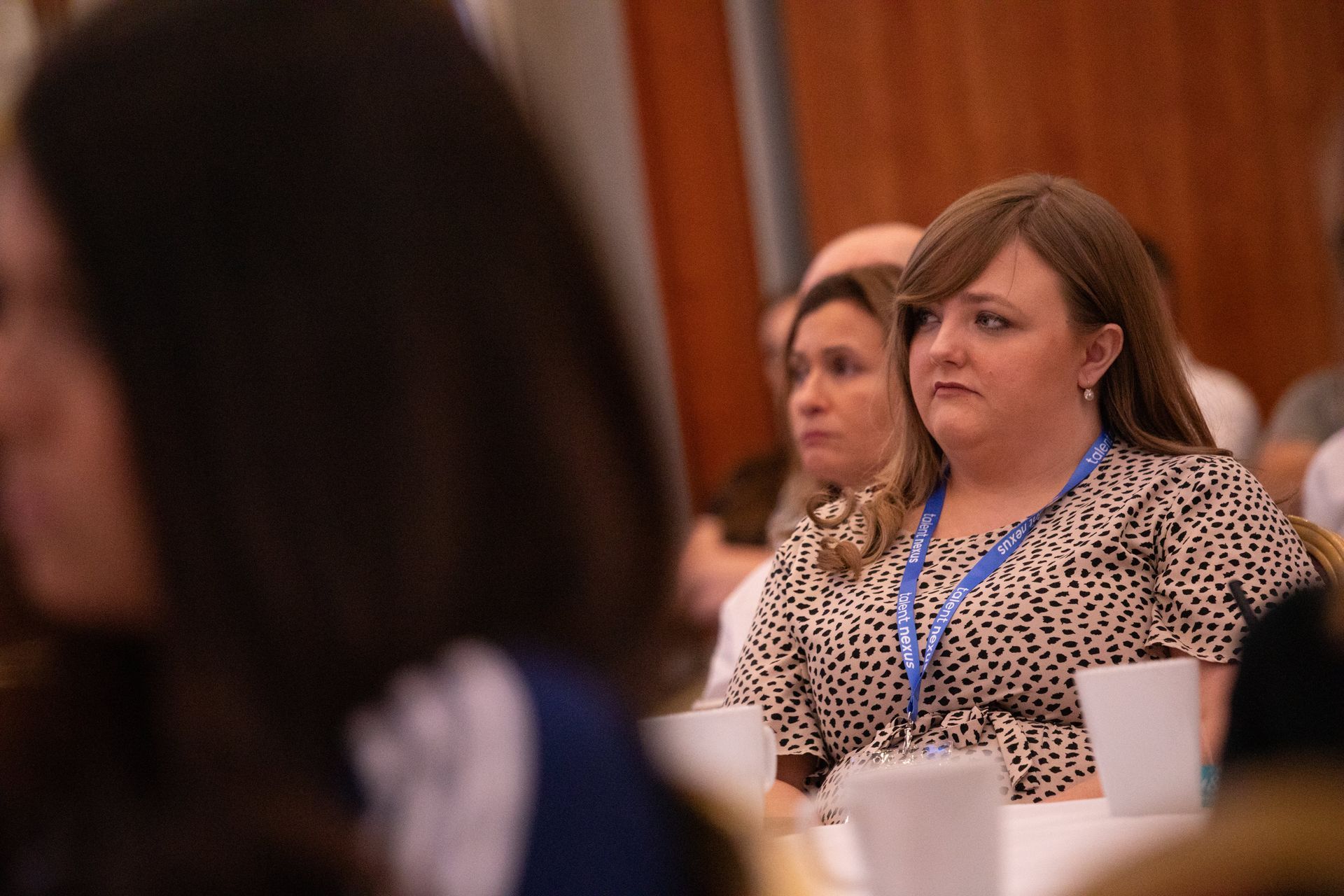 A group of people are sitting at a table in a room.