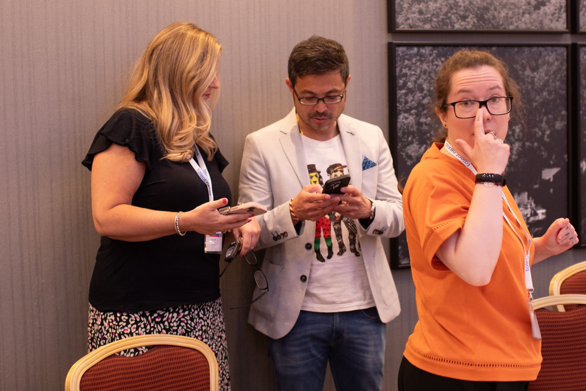 A group of people are standing next to each other in a room.