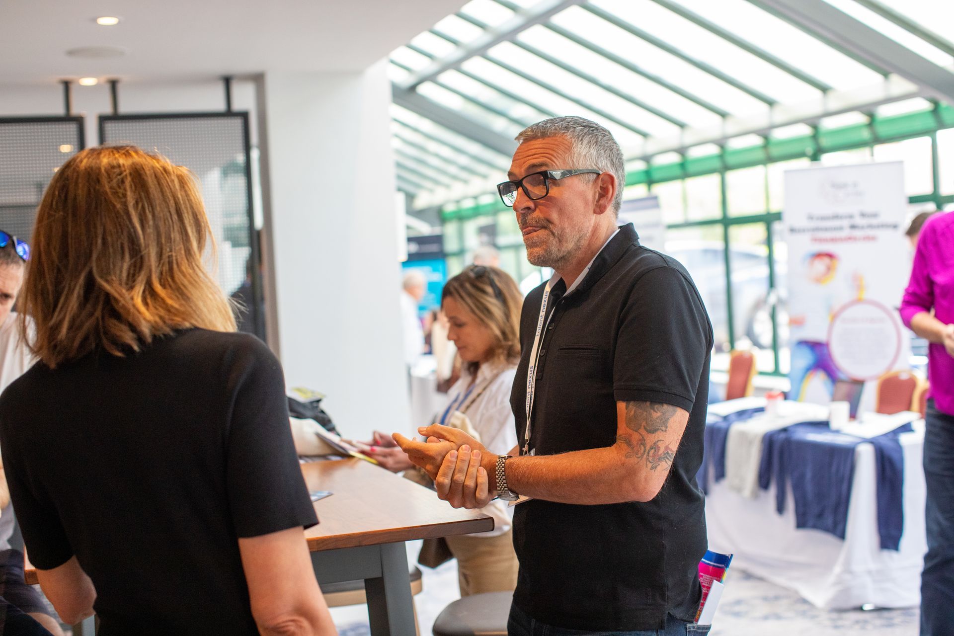 A man and a woman are talking to each other in a room.