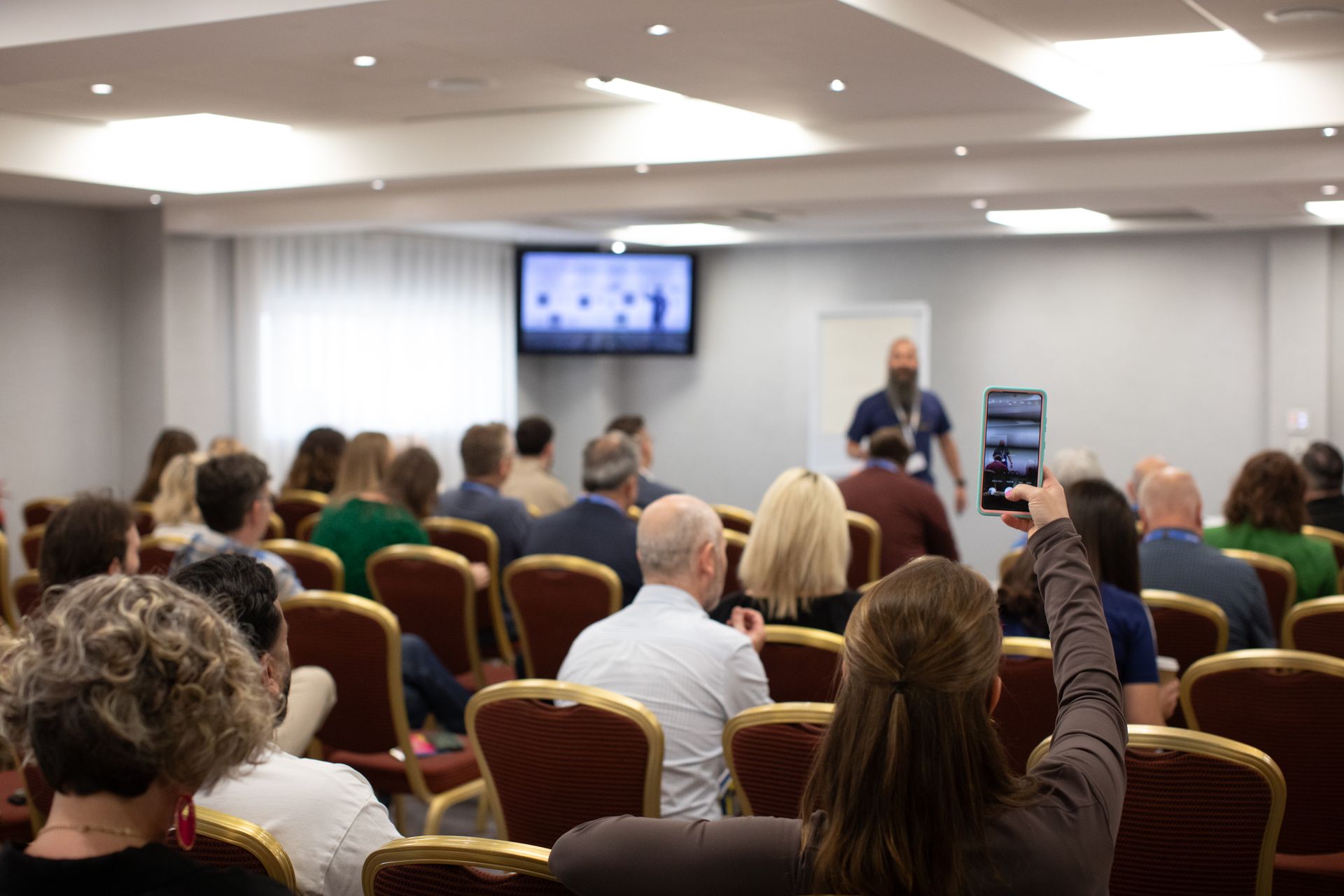 A man is giving a presentation to a group of people in a conference room.