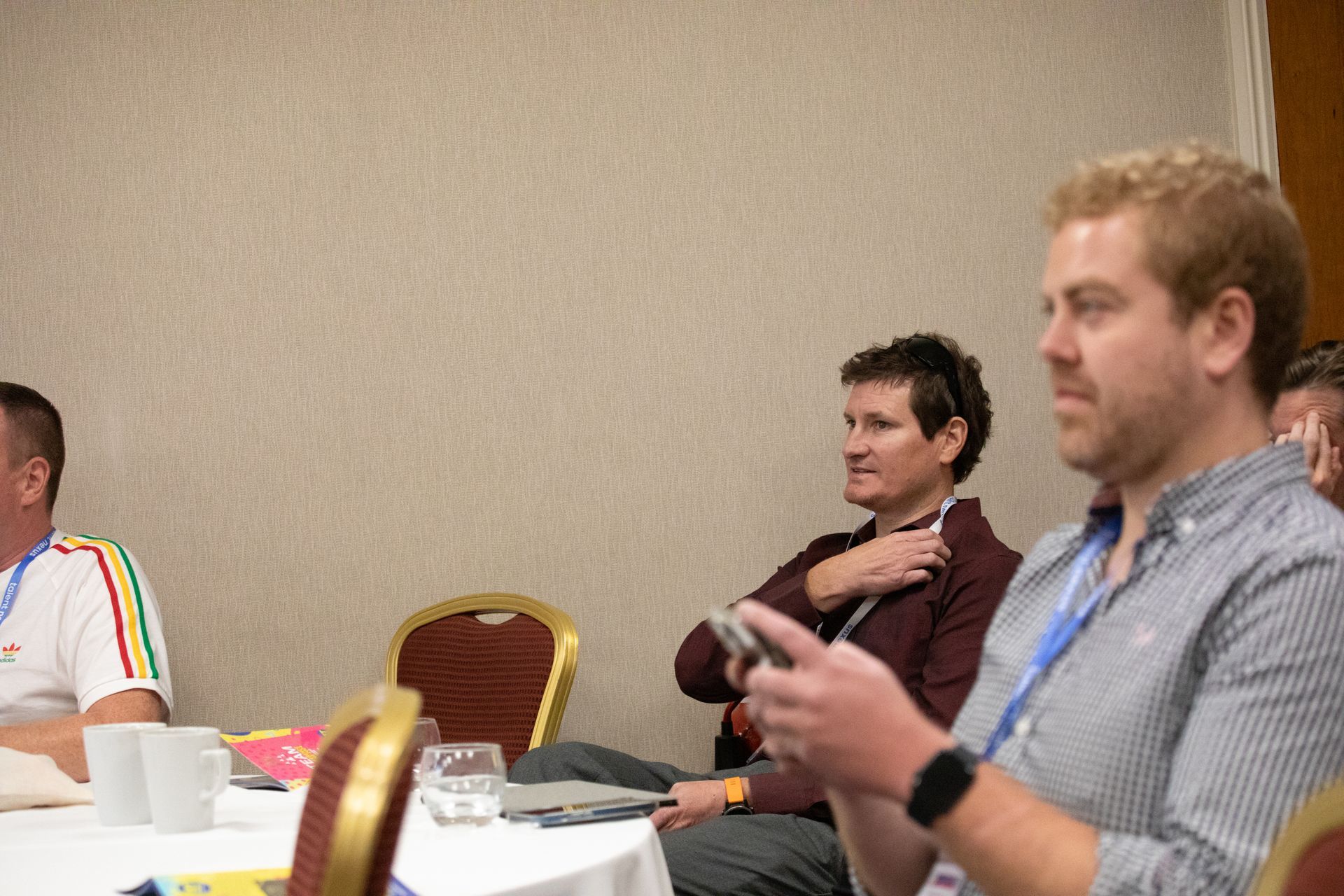 A group of people are sitting at a table in a room.