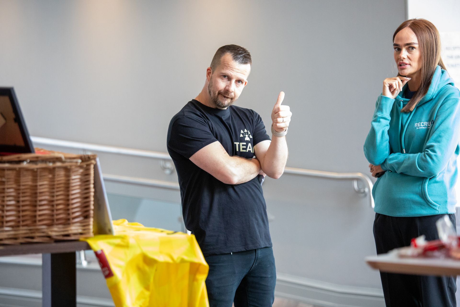 A man and a woman are standing next to each other in a room.
