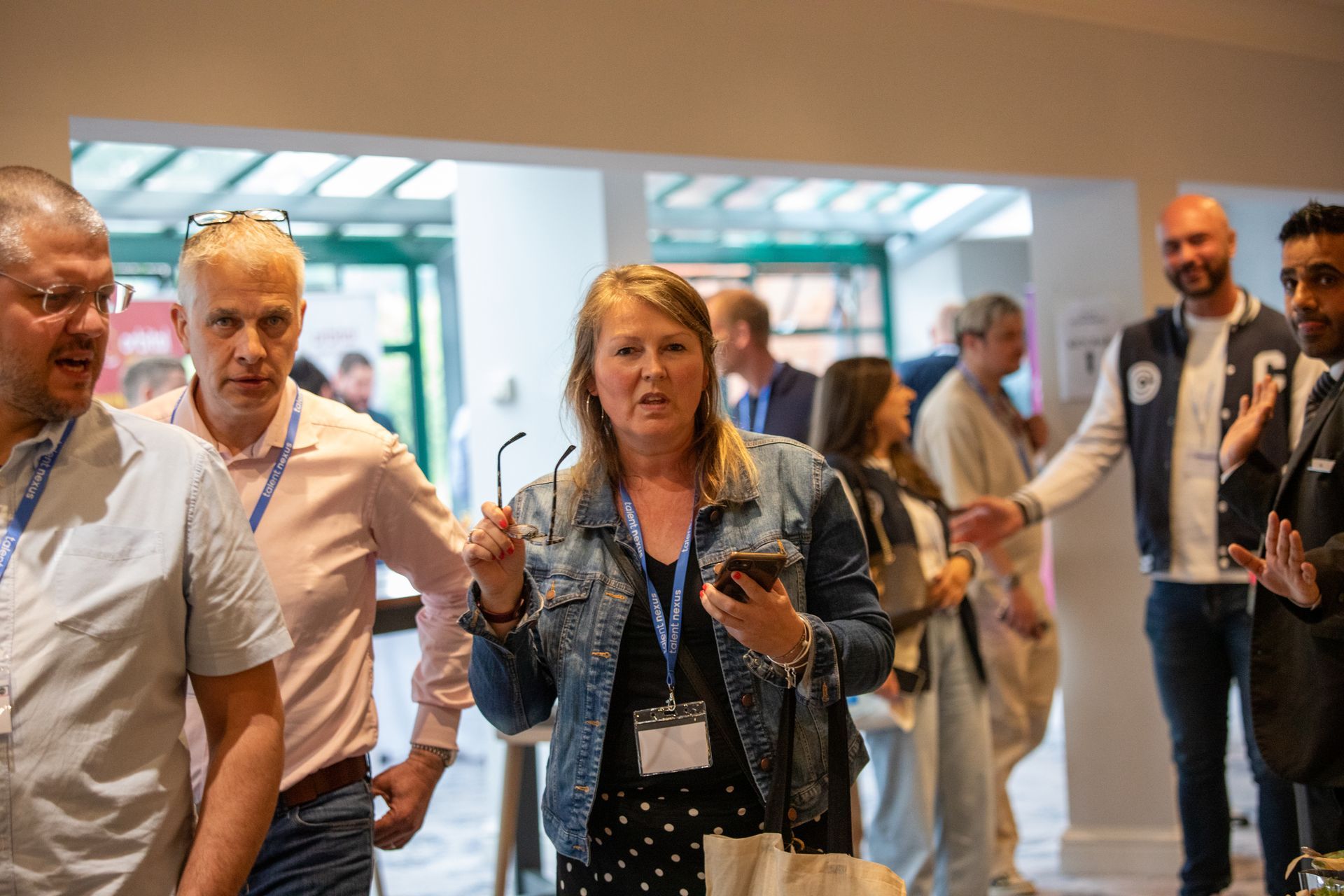 A group of people are walking down a hallway.