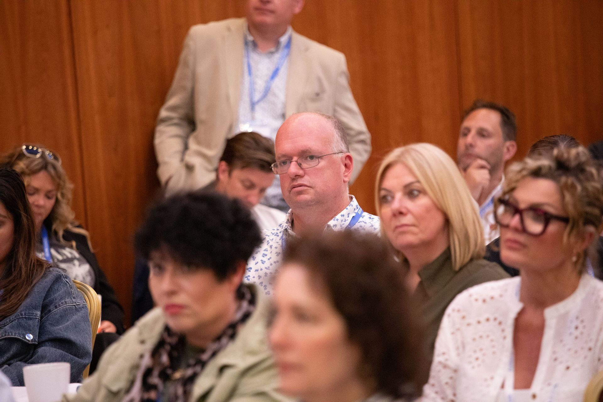 A group of people are sitting in a room watching a presentation.