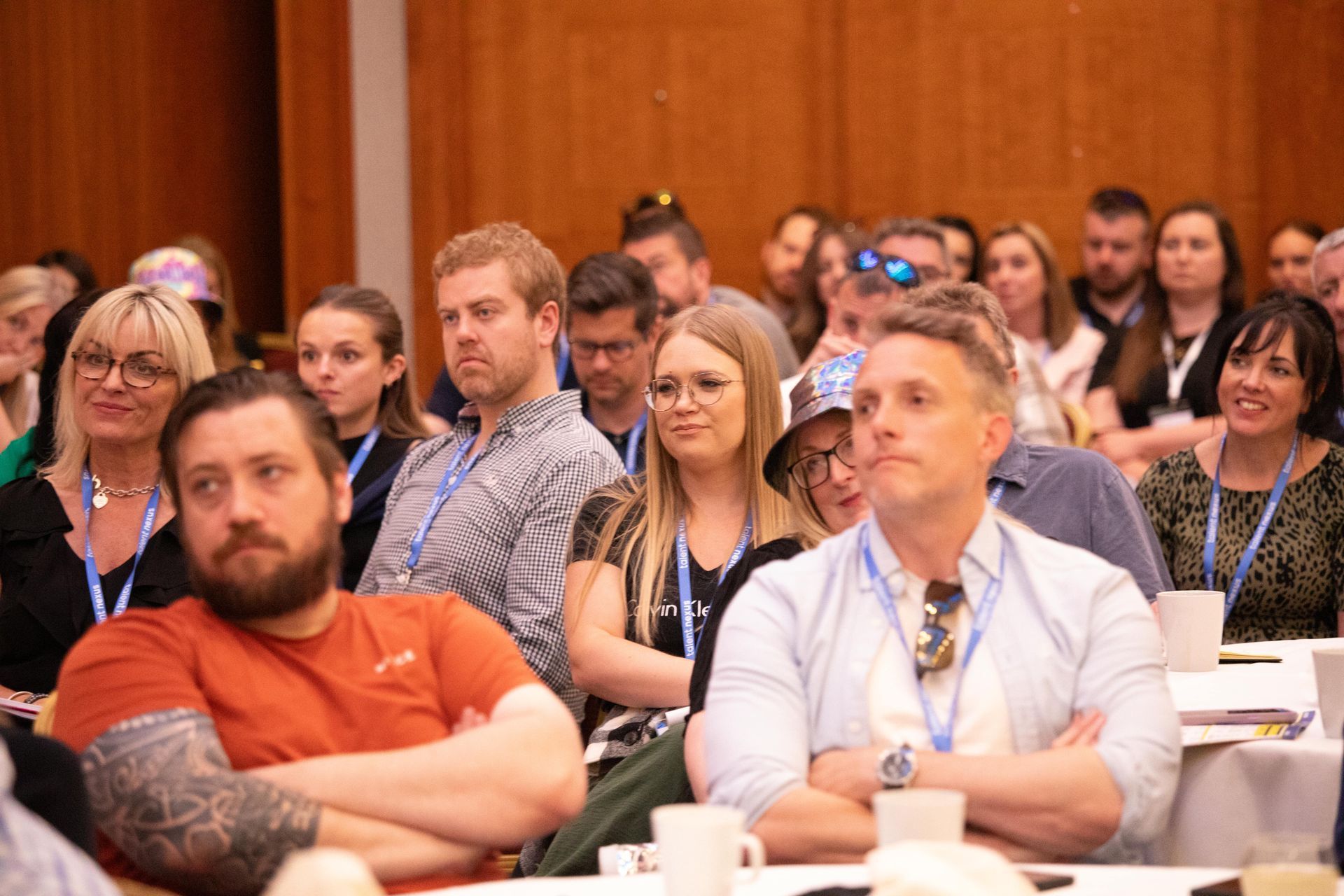 A group of people are sitting at tables in a room.