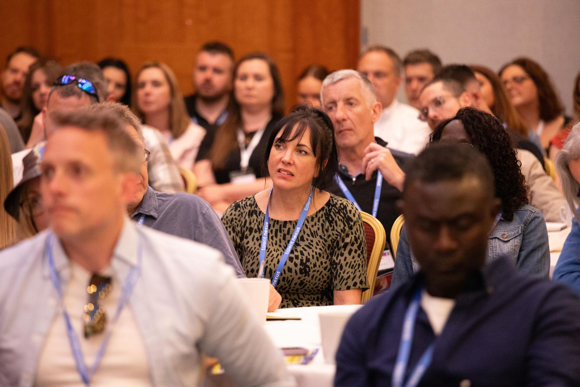 A group of people are sitting in a classroom at a conference.
