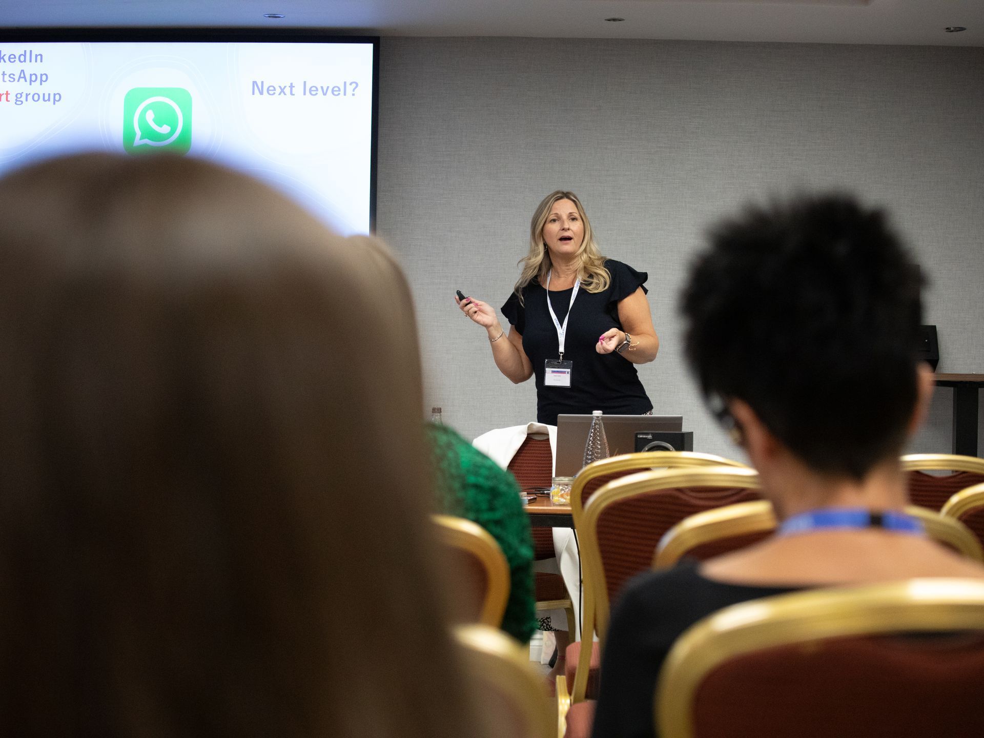A woman is giving a presentation to a group of people sitting in chairs.