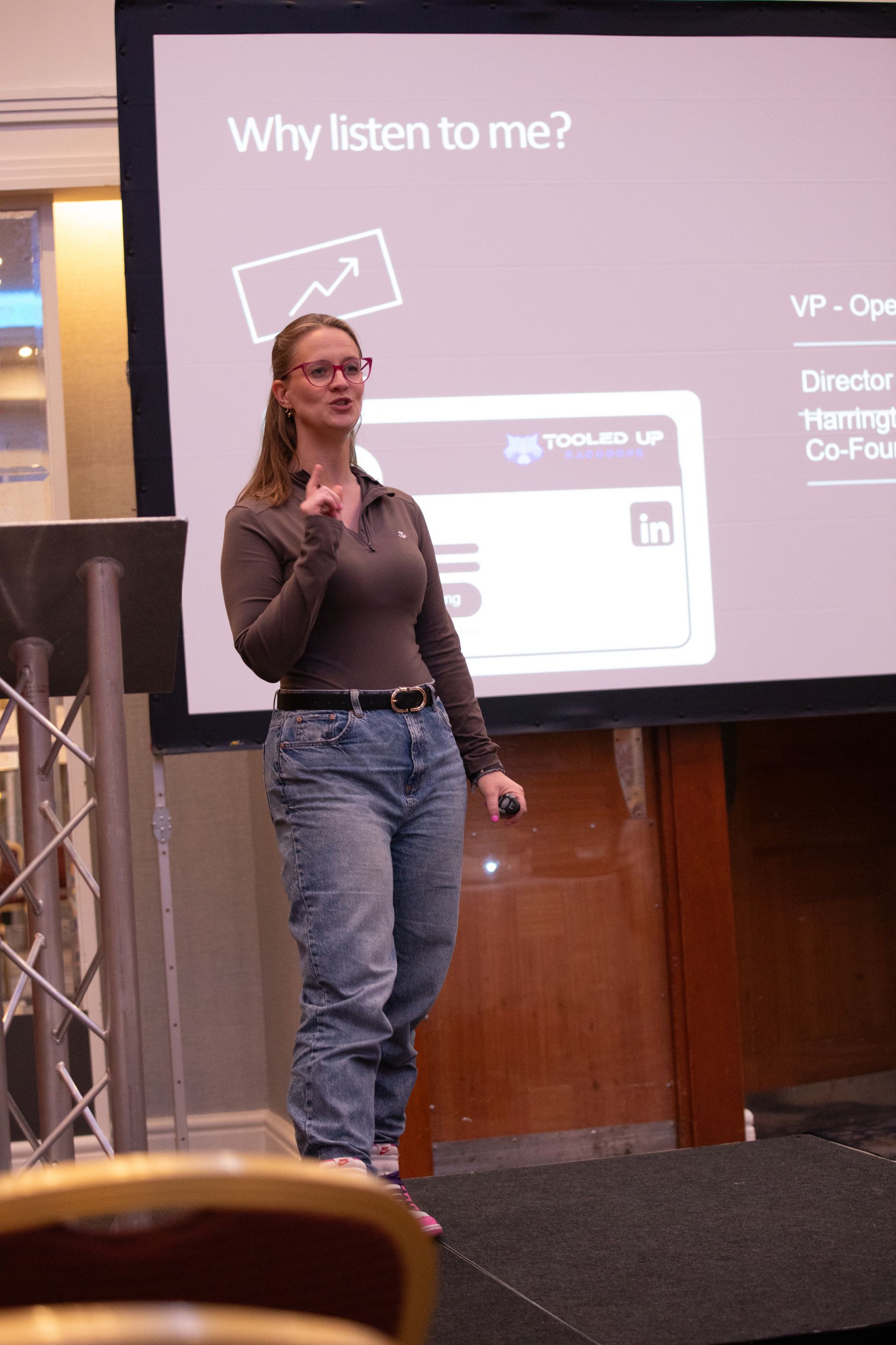 A woman is giving a presentation on why listen to me