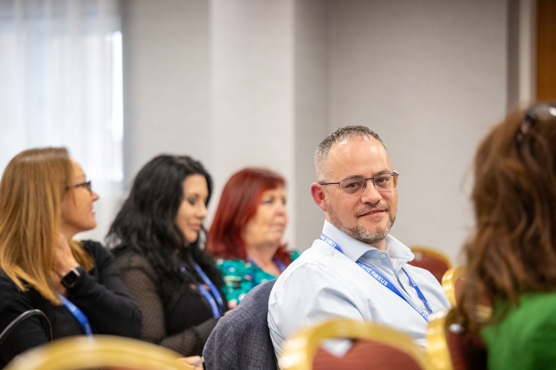 A group of people are sitting in chairs at a conference.