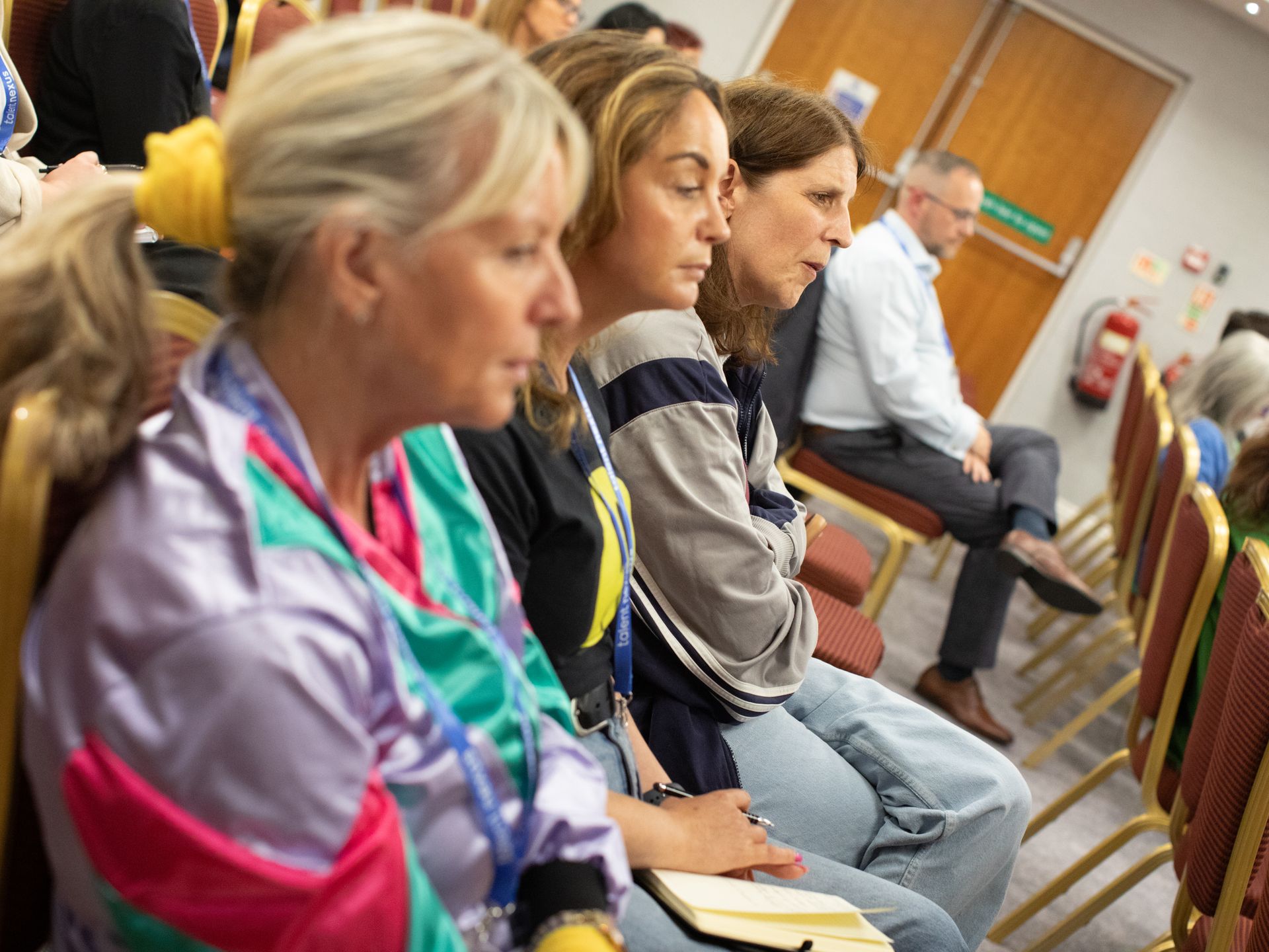 A group of people are sitting in chairs in a room.