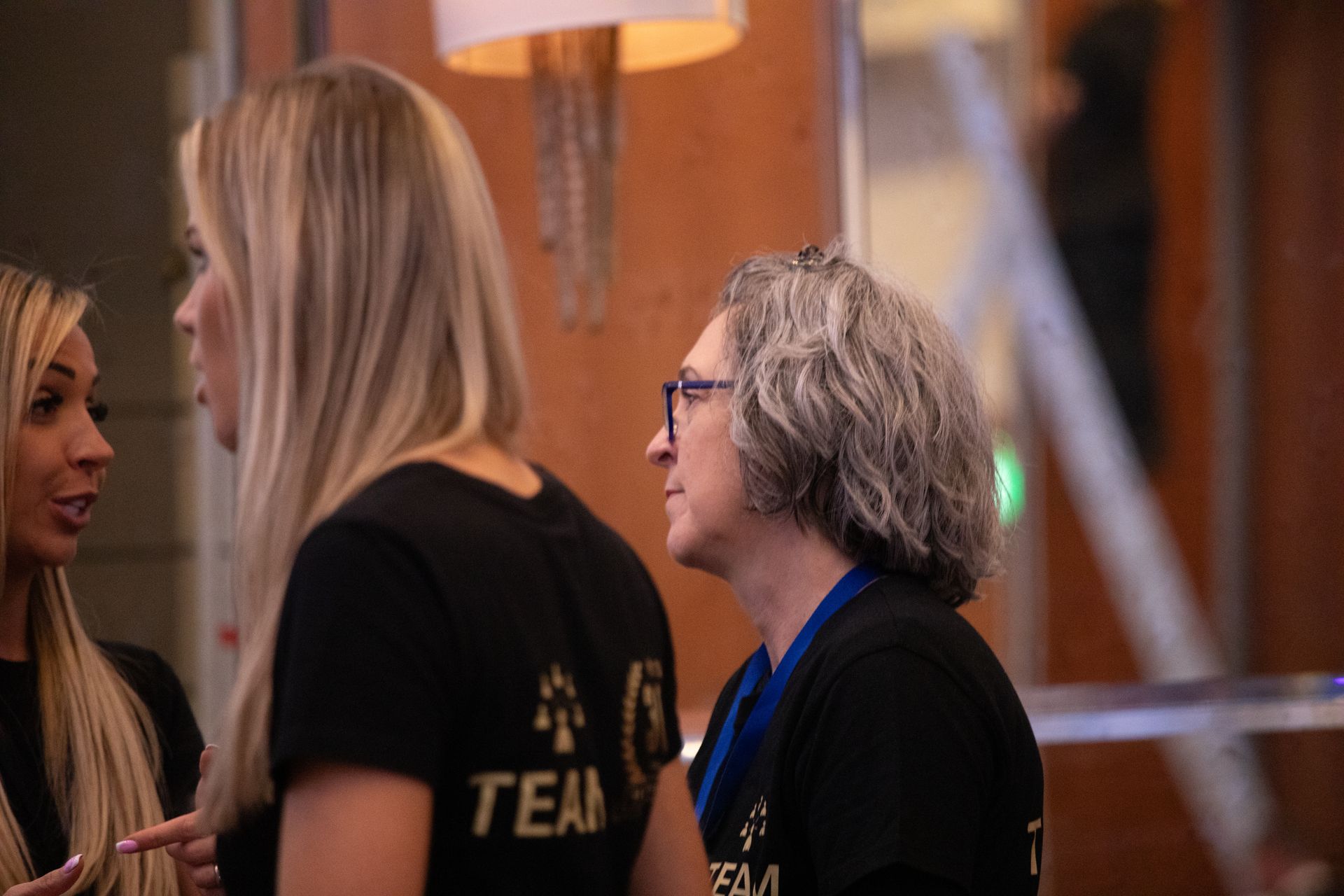 A group of women are standing next to each other and talking.