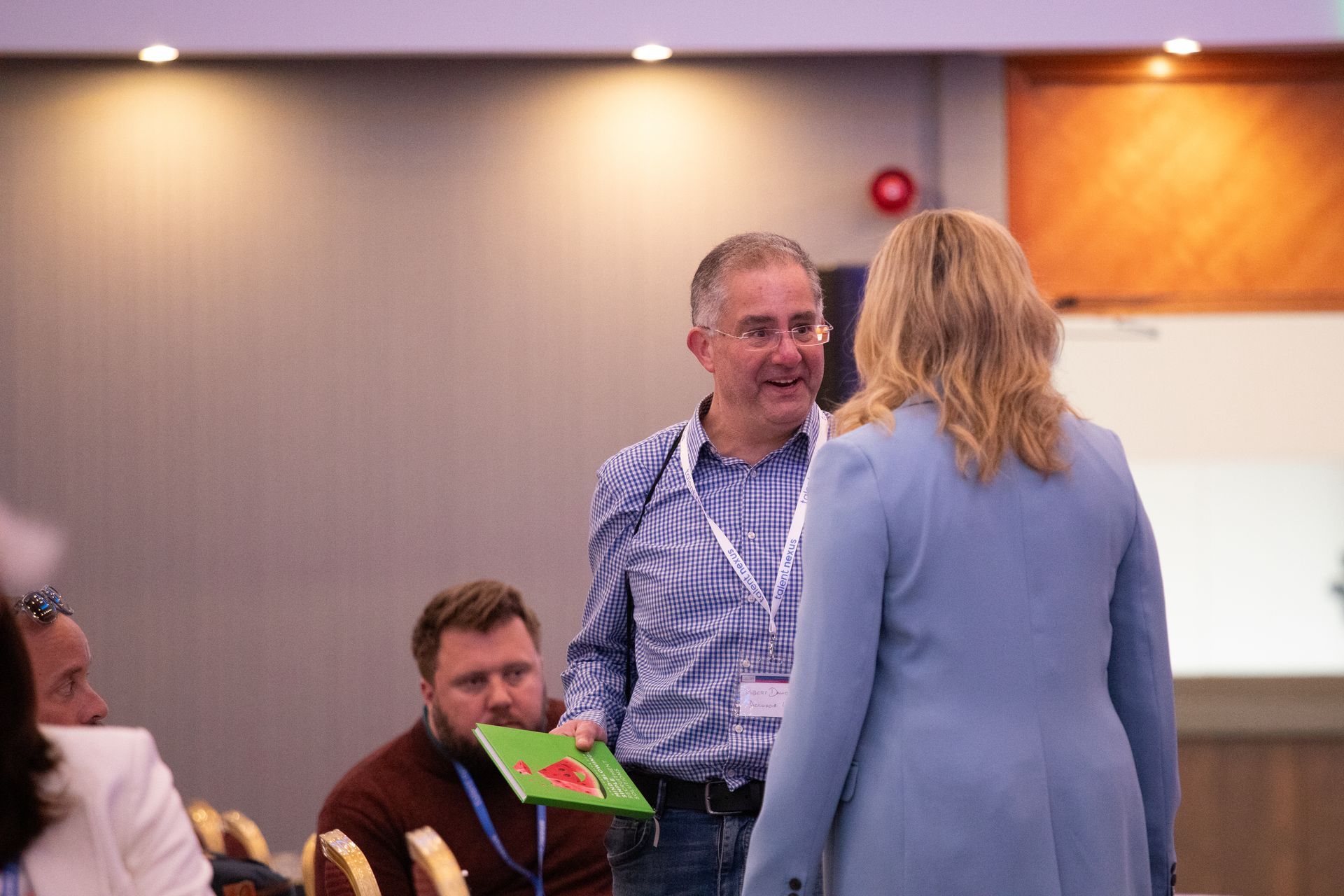 A man and a woman are standing next to each other in a room.
