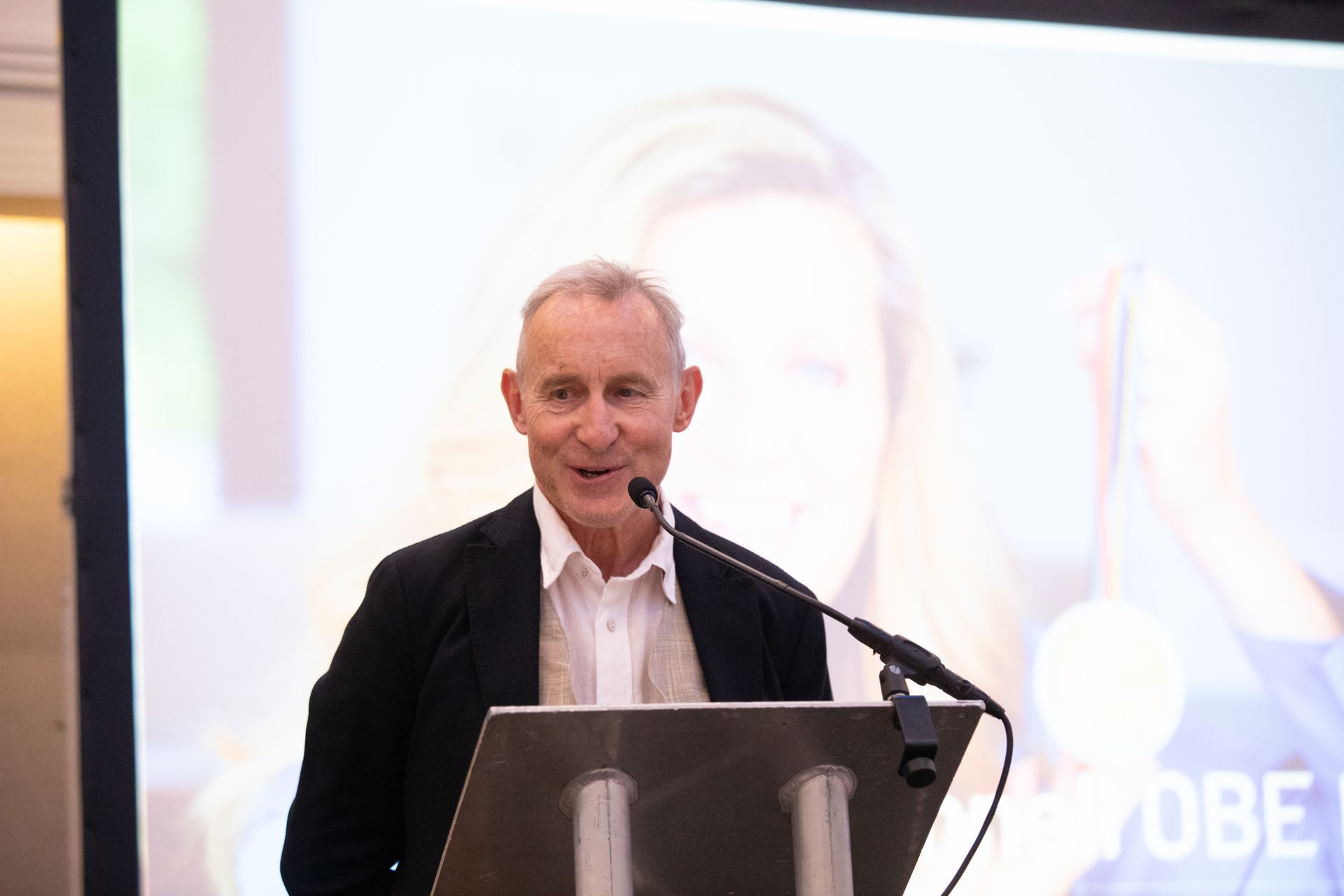 A man is standing at a podium giving a speech.