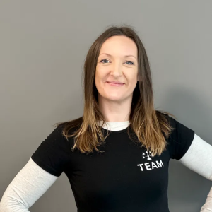 A woman wearing a black shirt that says team on it