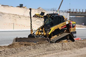 A bulldozer is moving dirt on a construction site.