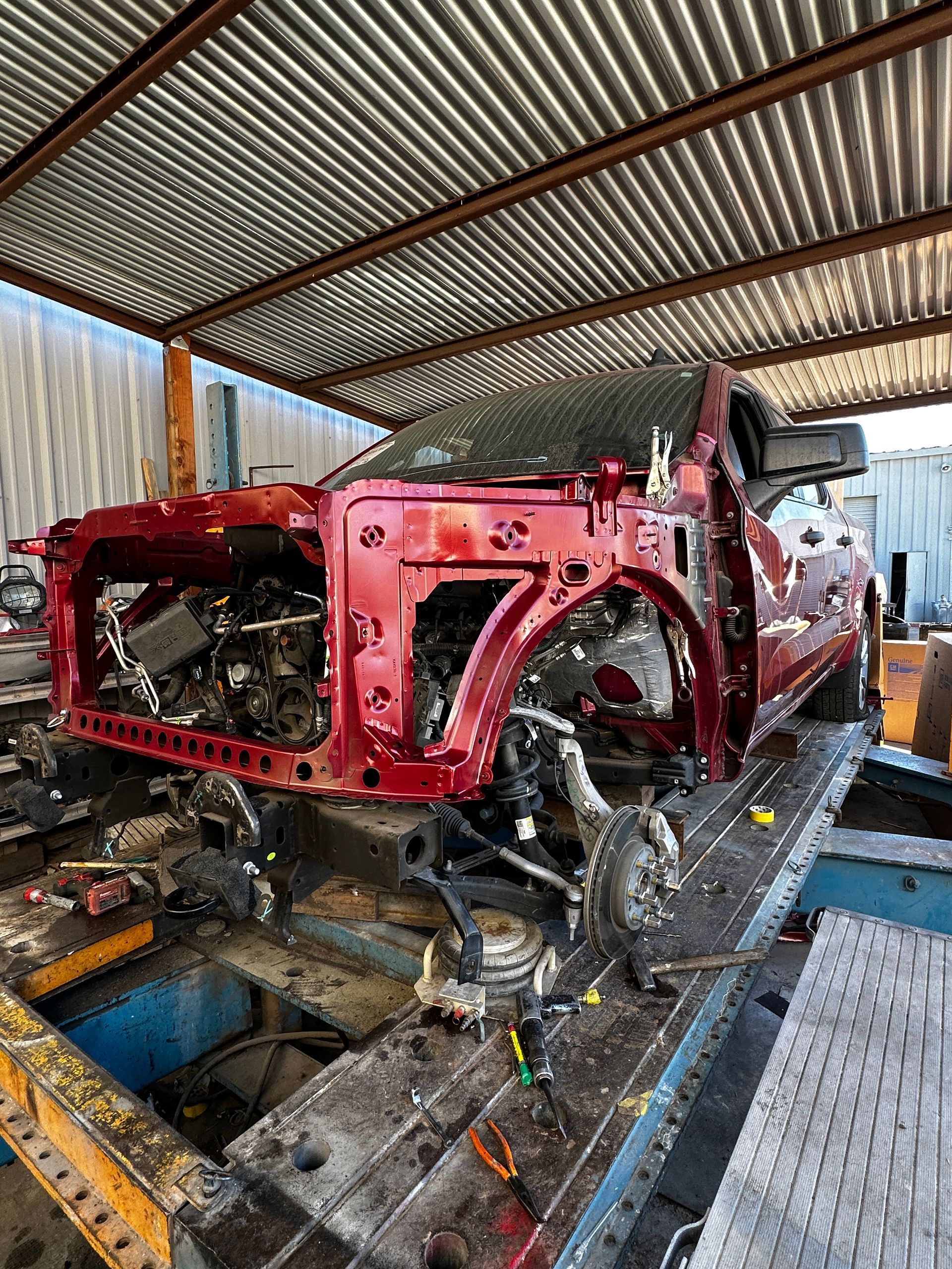 Frame damage repair actively being completed by technicians