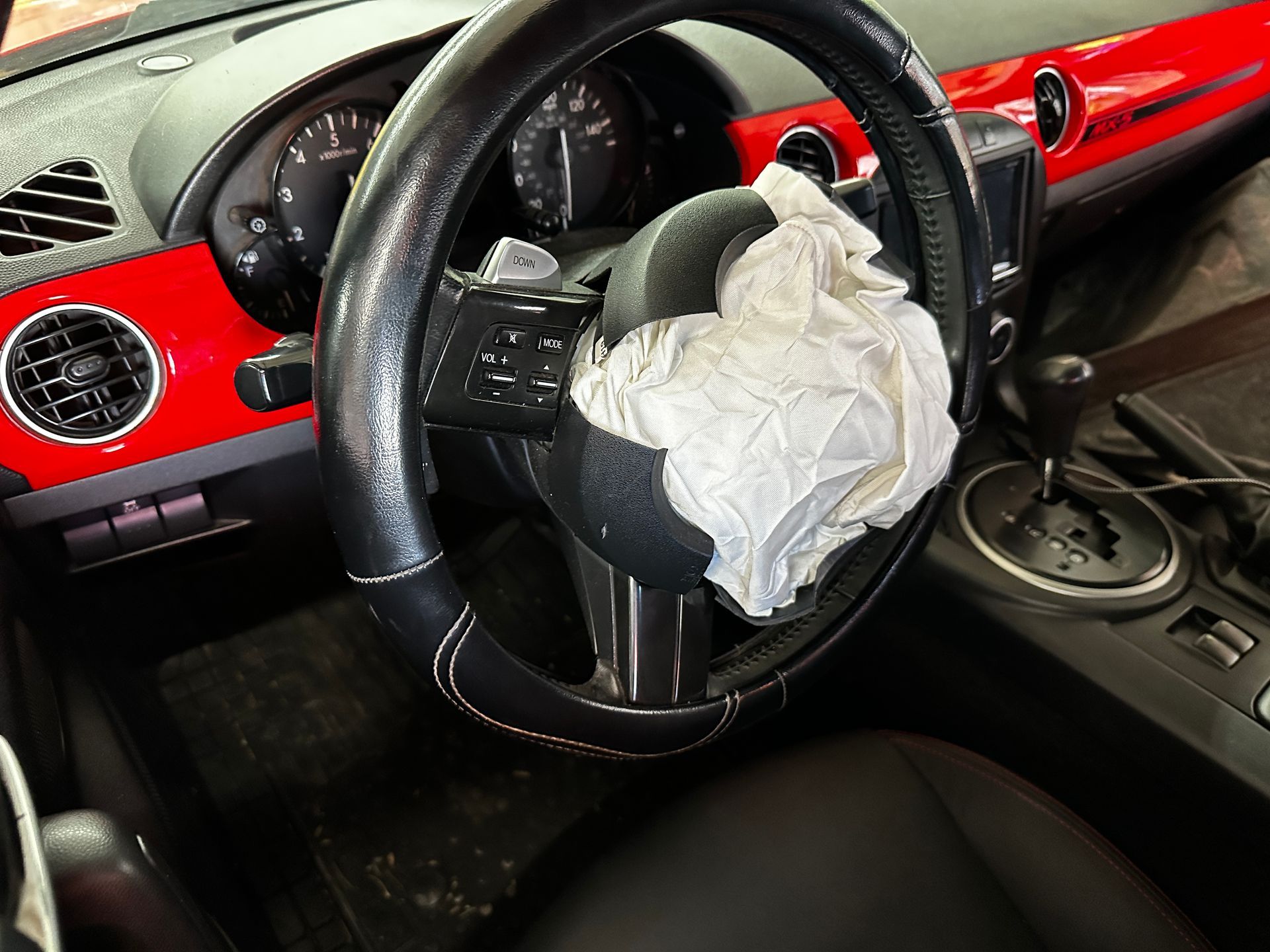 Pre‑repair photo showing airbag deployment from collision
