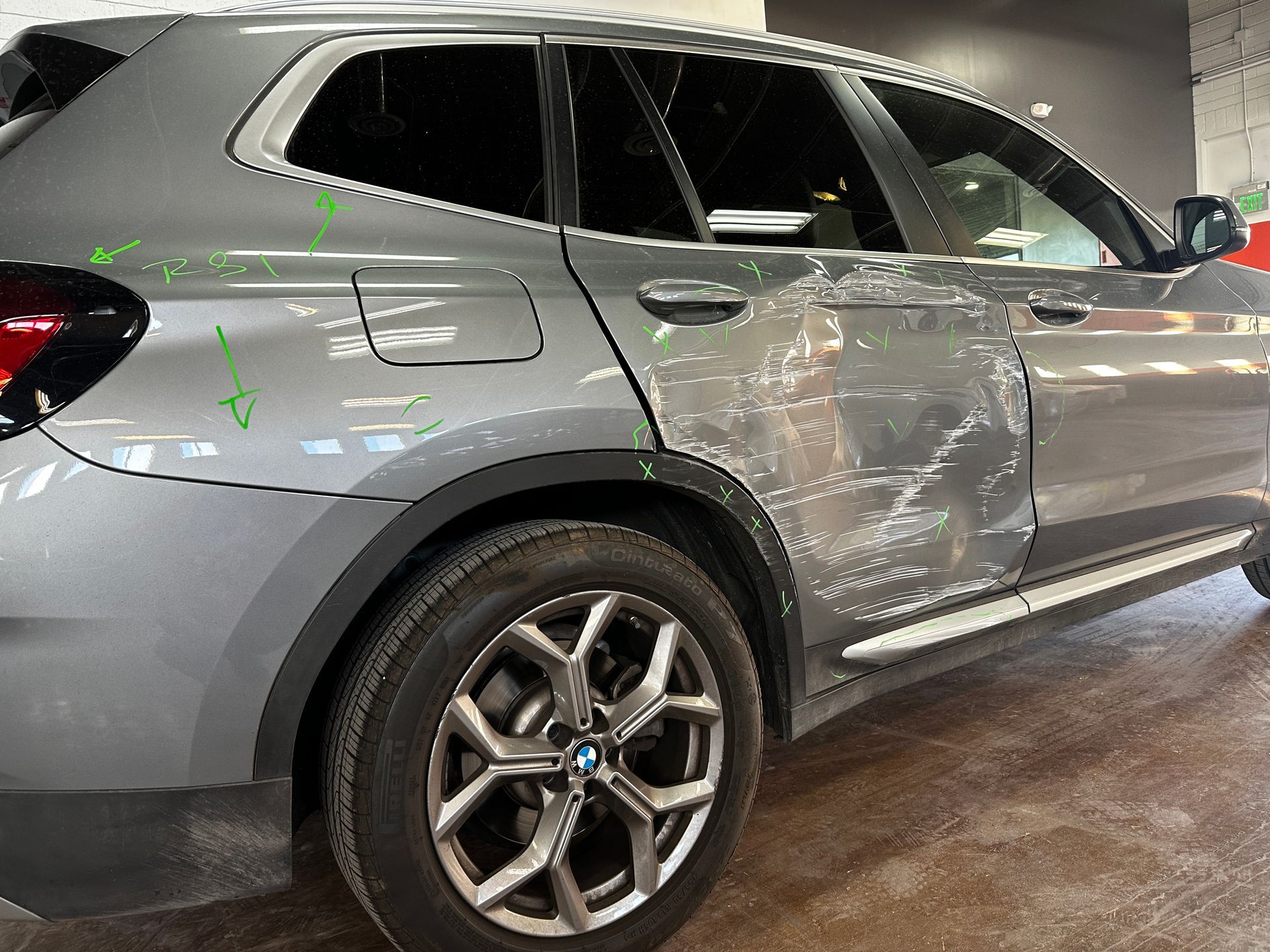 Car with severe door damage before collision repair in Phoenix