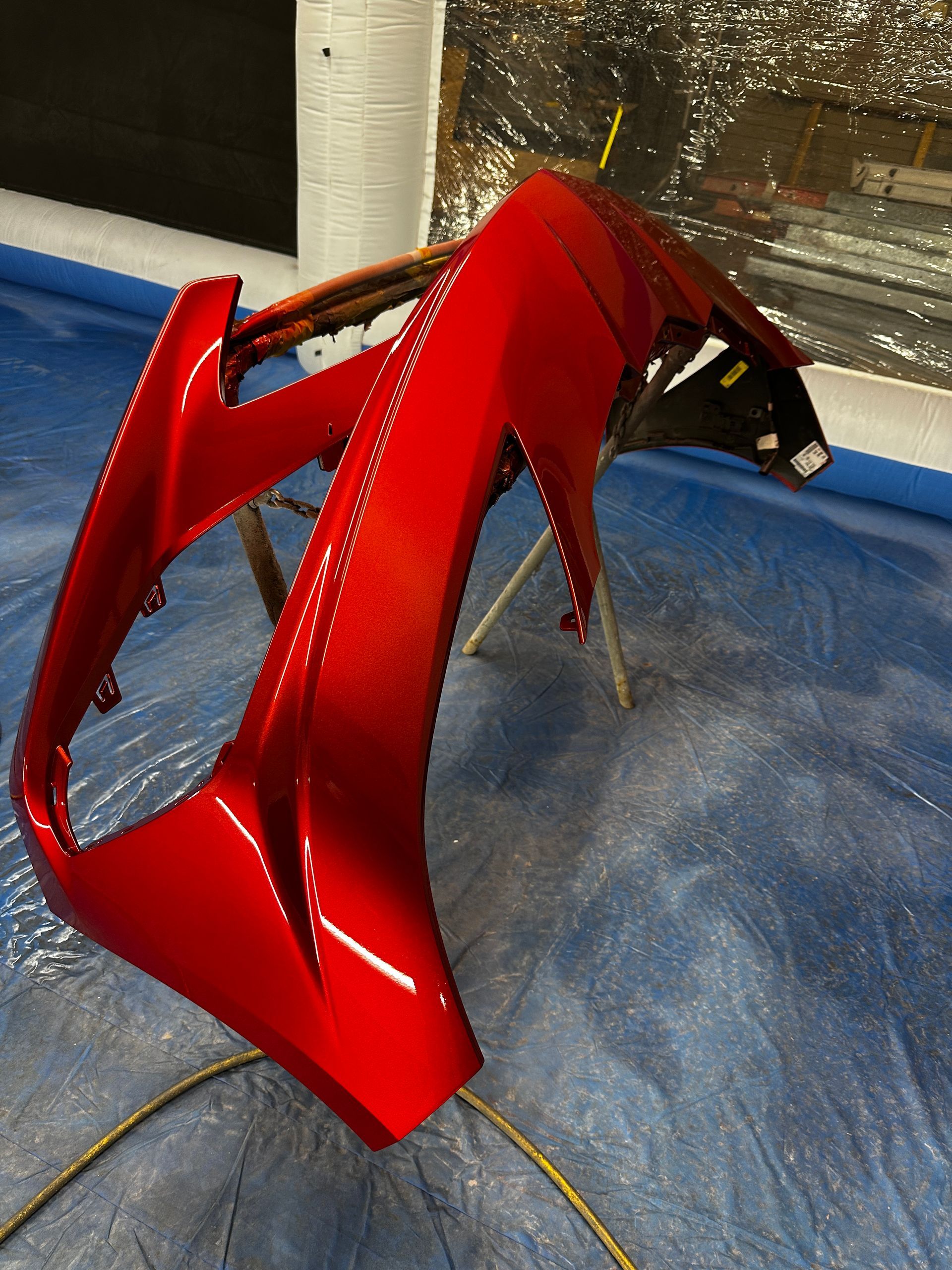 Painting bumper of car in Phoenix Zion Auto Body