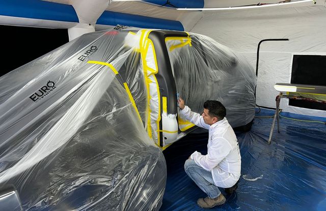 Vehicle covered for paint preparation in Phoenix collision shop
