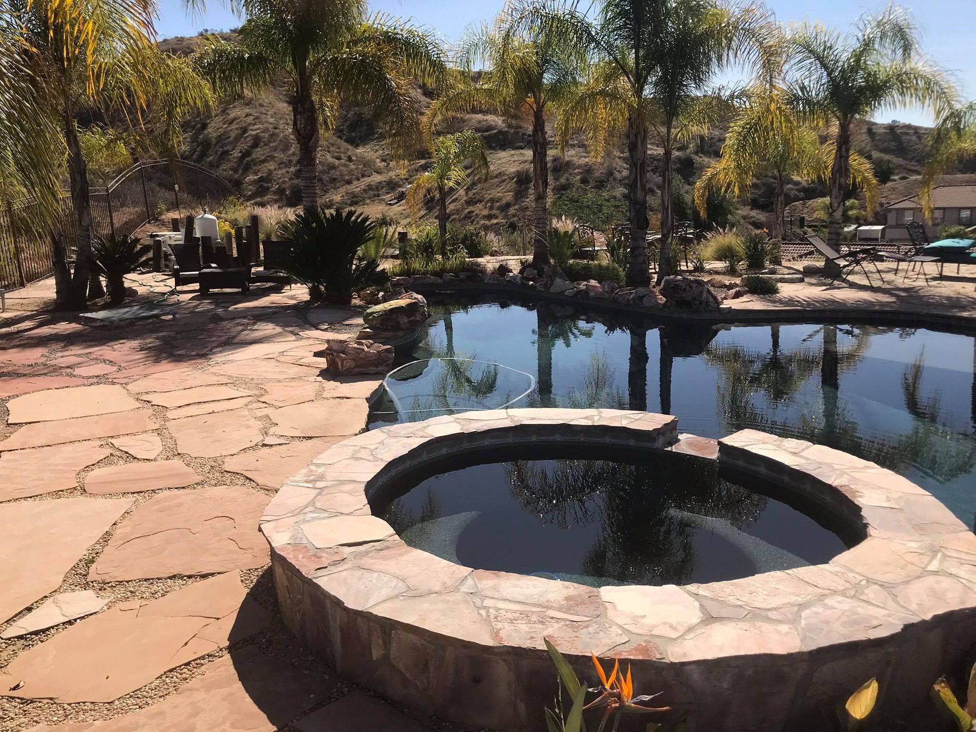 A pool with a hot tub in the middle of it