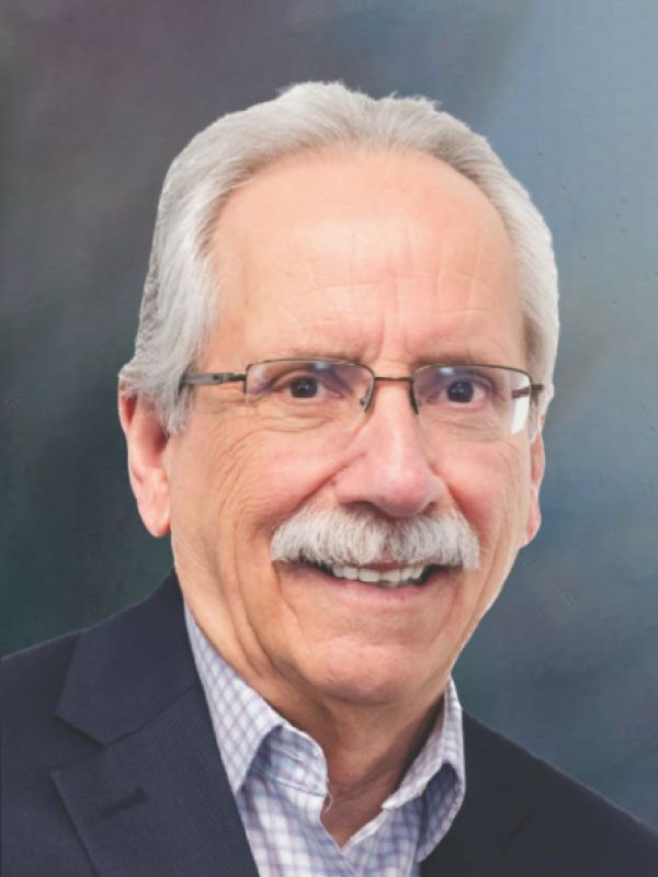 A man with glasses and a mustache is smiling for the camera.