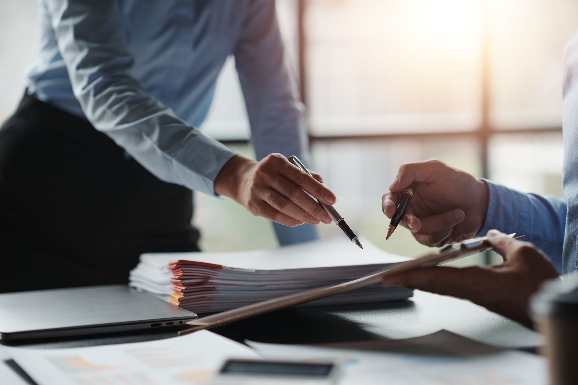 Professionals collaborate at a desk
