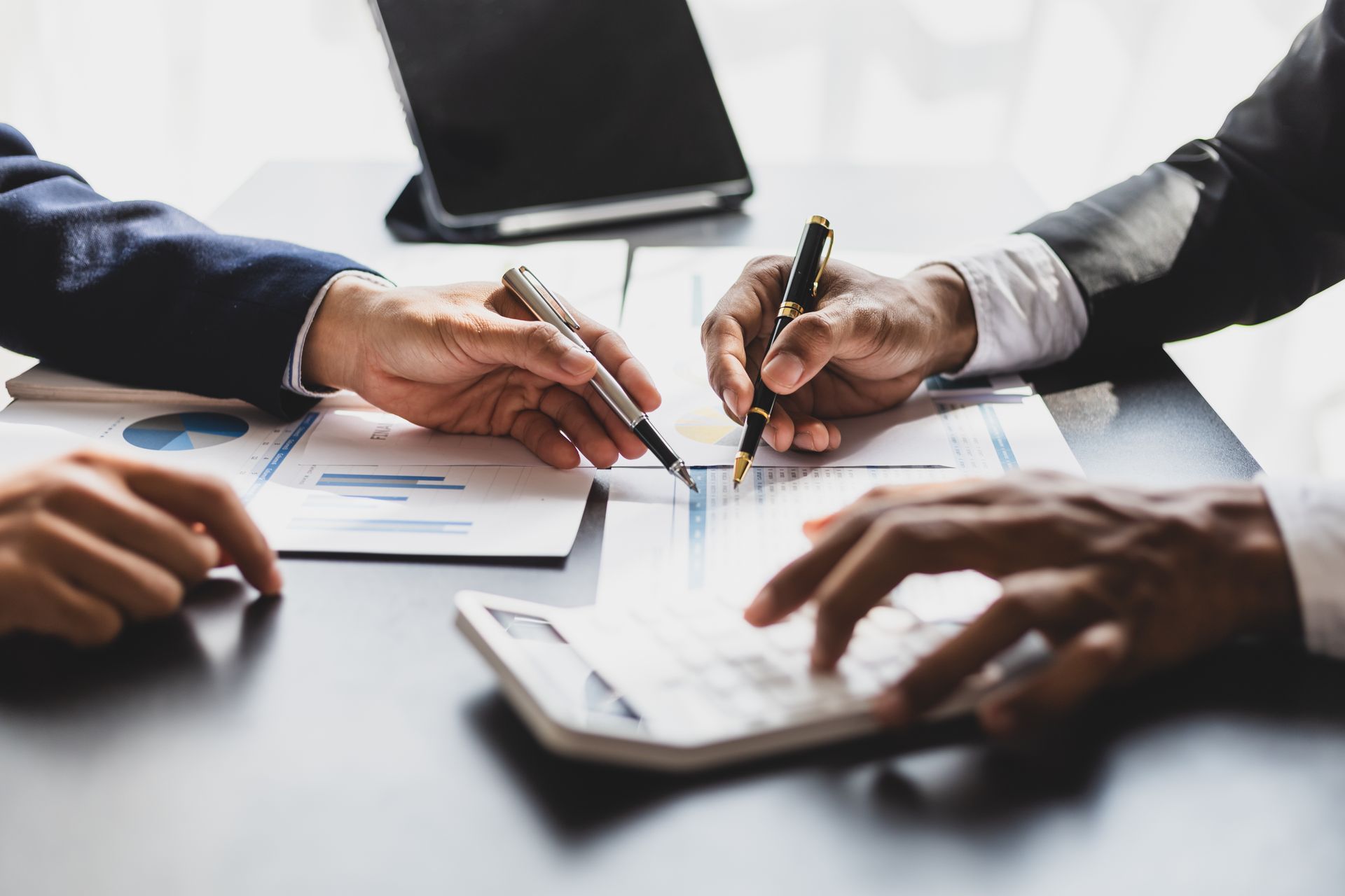 Professionals collaborate at a desk