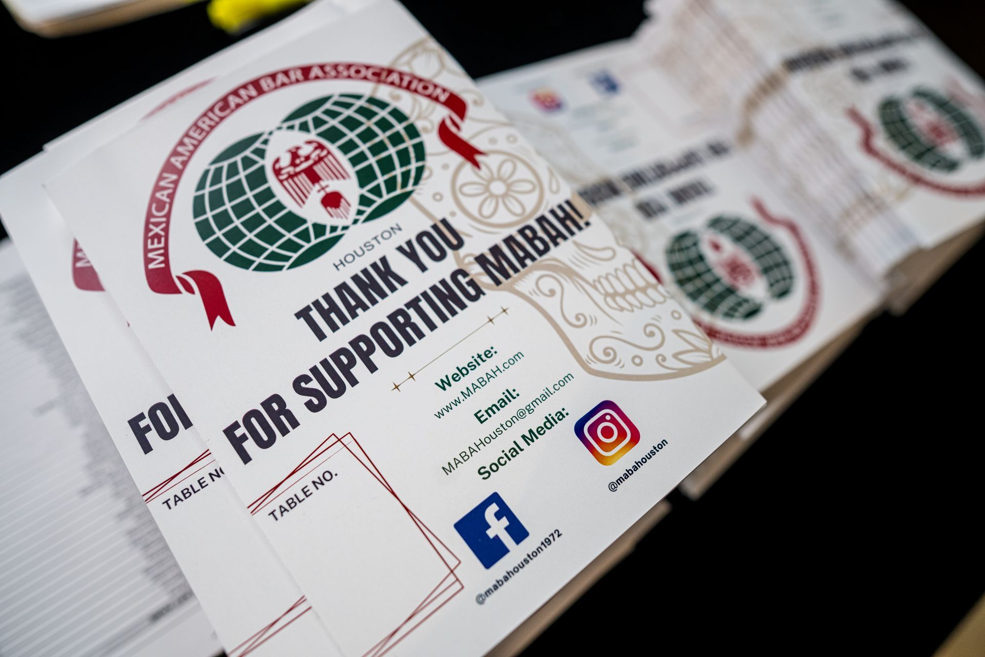 Stacks of white printed cards with the Mexican American Bar Association logo, thanking supporters.