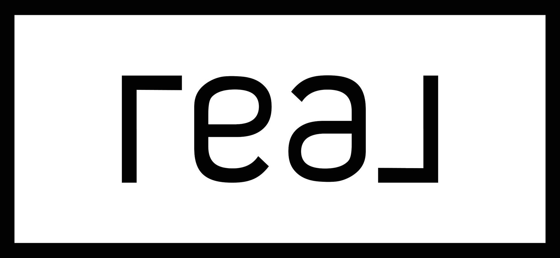 Black mirrored text reading “real” on a white background