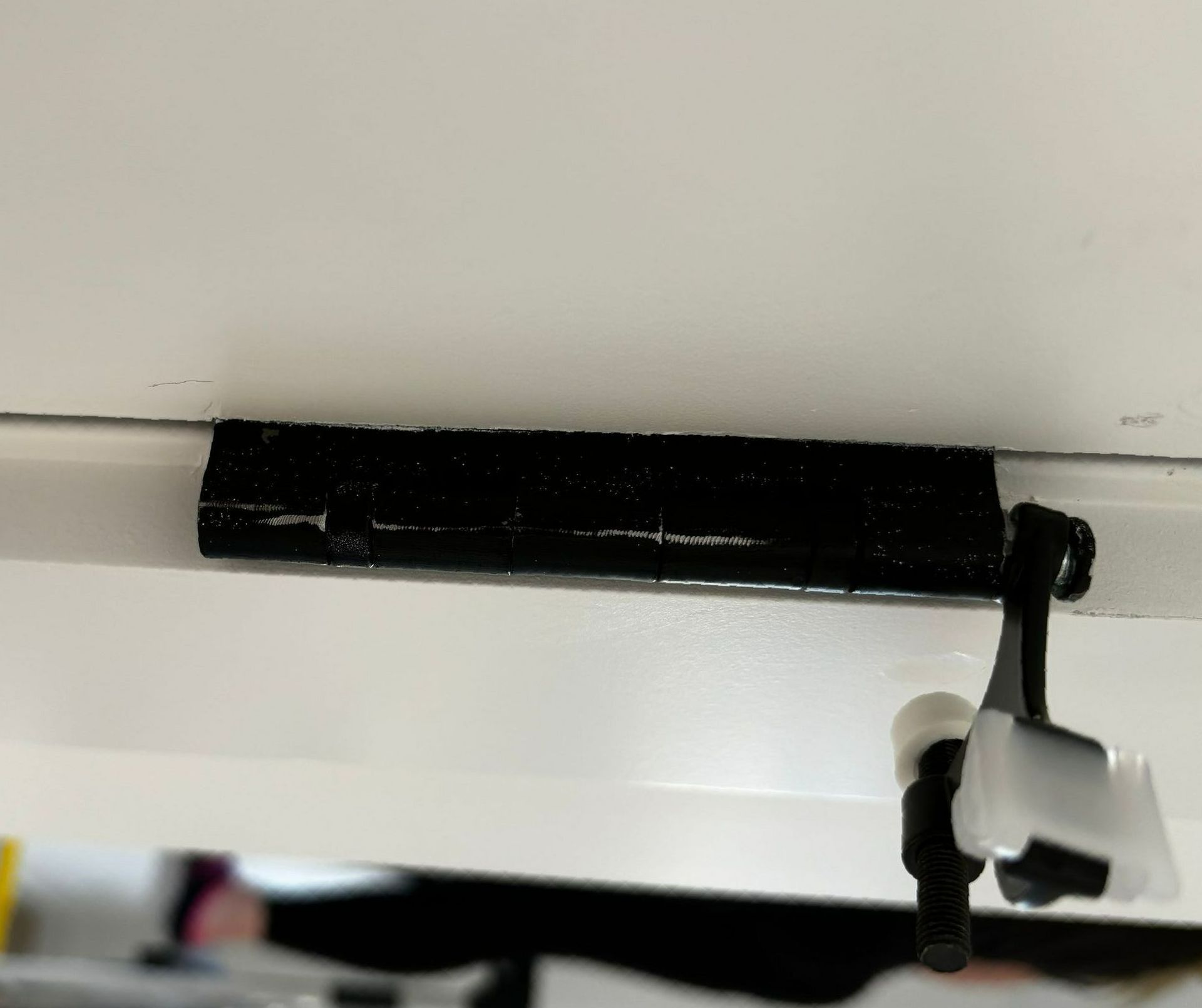 A close up of a black object on a white surface