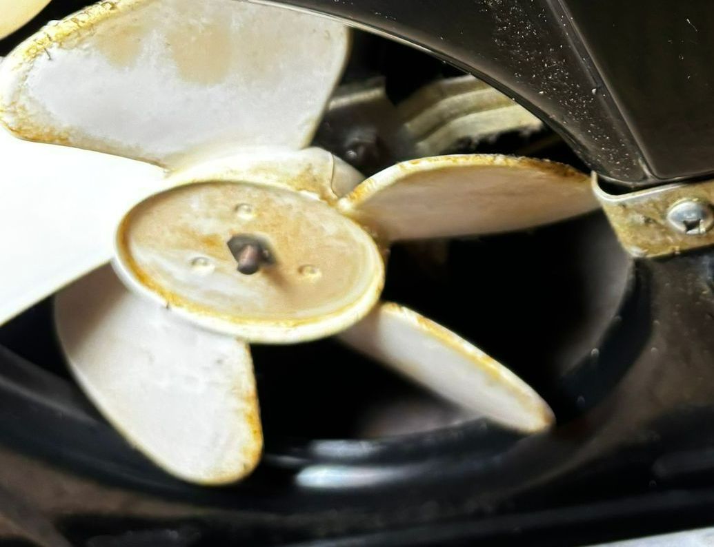 A close up of a fan with a few blades missing