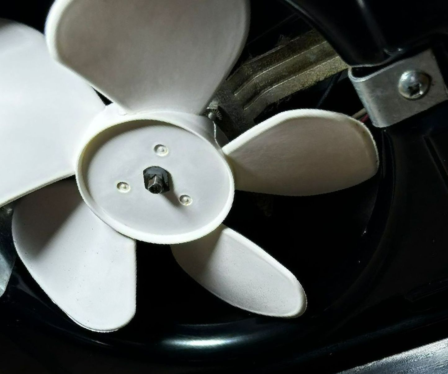 A close up of a white fan on a black background