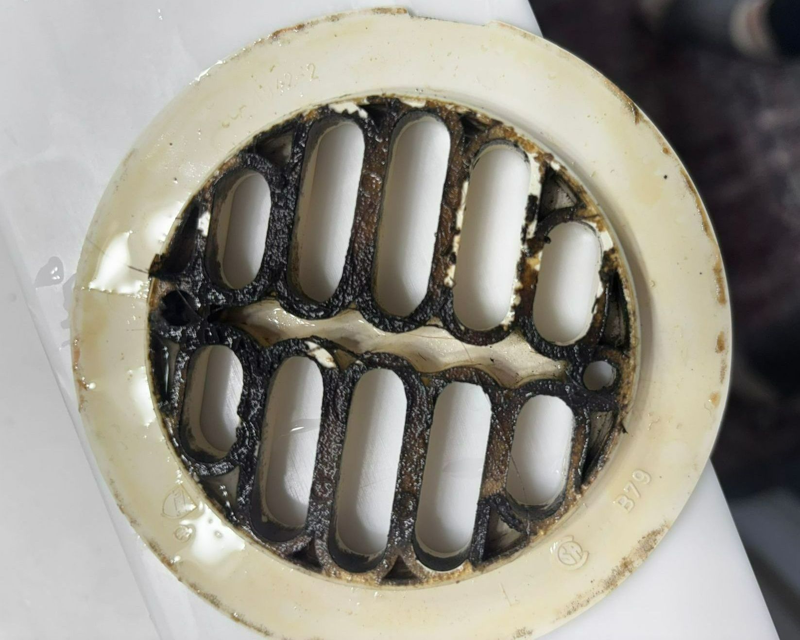 A close up of a drain with holes in it