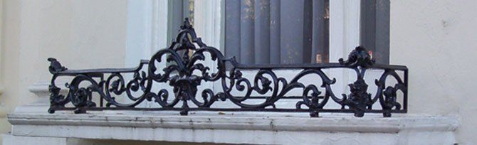 Wrought iron design in front of a window