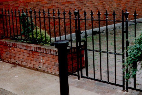 Black wrought iron fence & gate