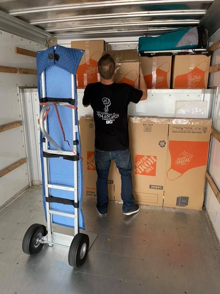A moving truck loaded with furniture, including chairs and a couch.