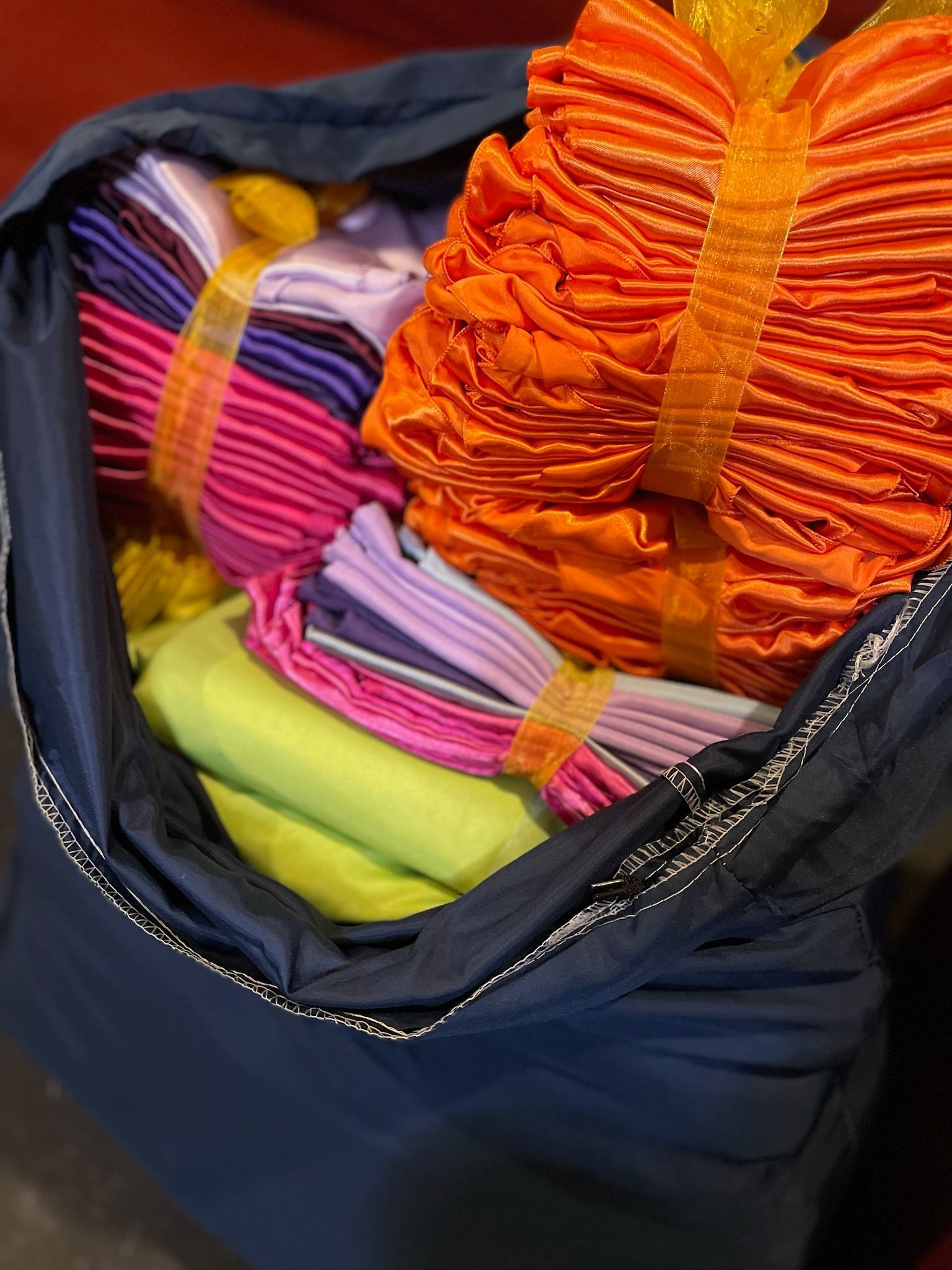A bag filled with a variety of colorful yarns