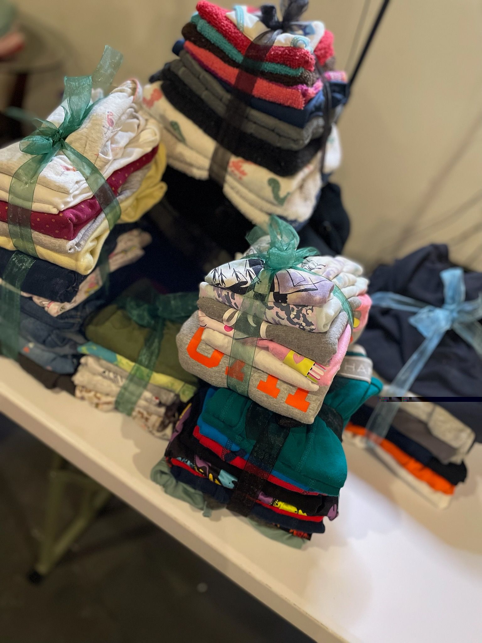 A table topped with stacks of towels and socks.