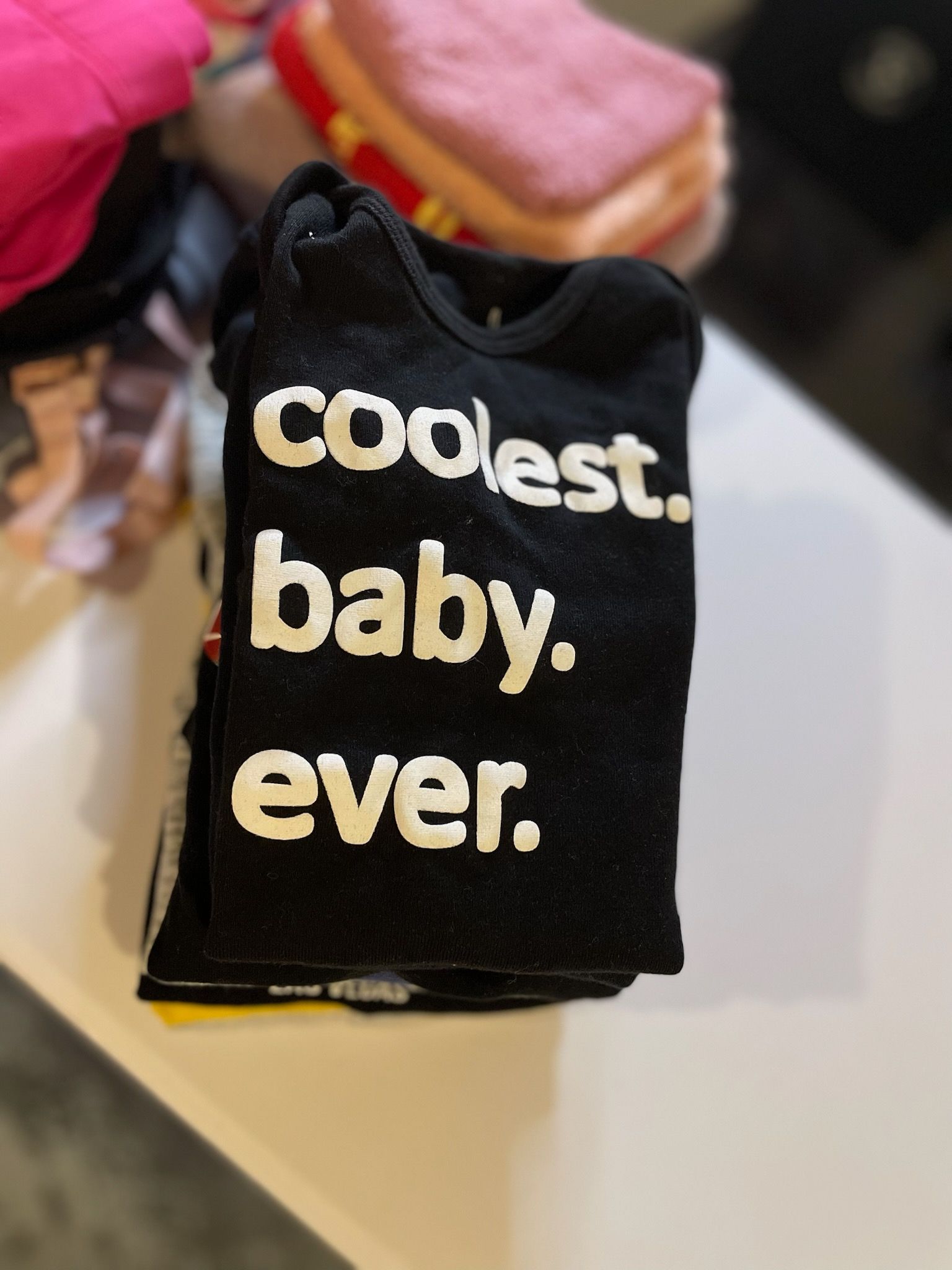 Black onesie with white text reading 