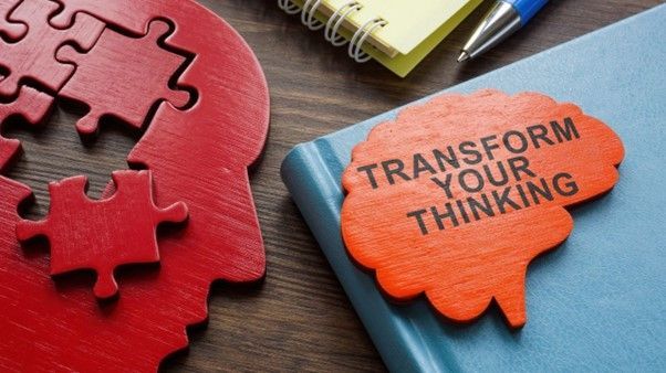 Red wooden head silhouette with puzzle pieces and