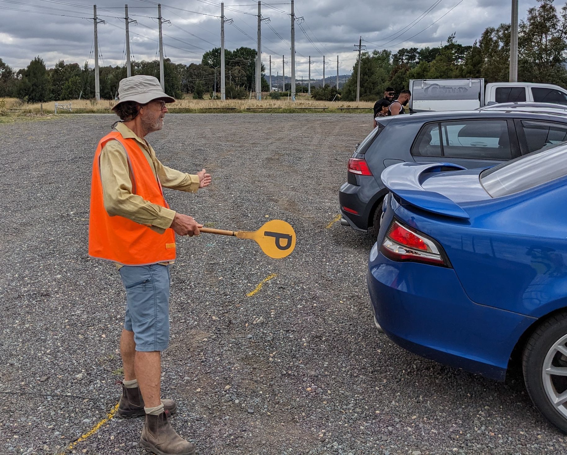 A member showing drivers where to park