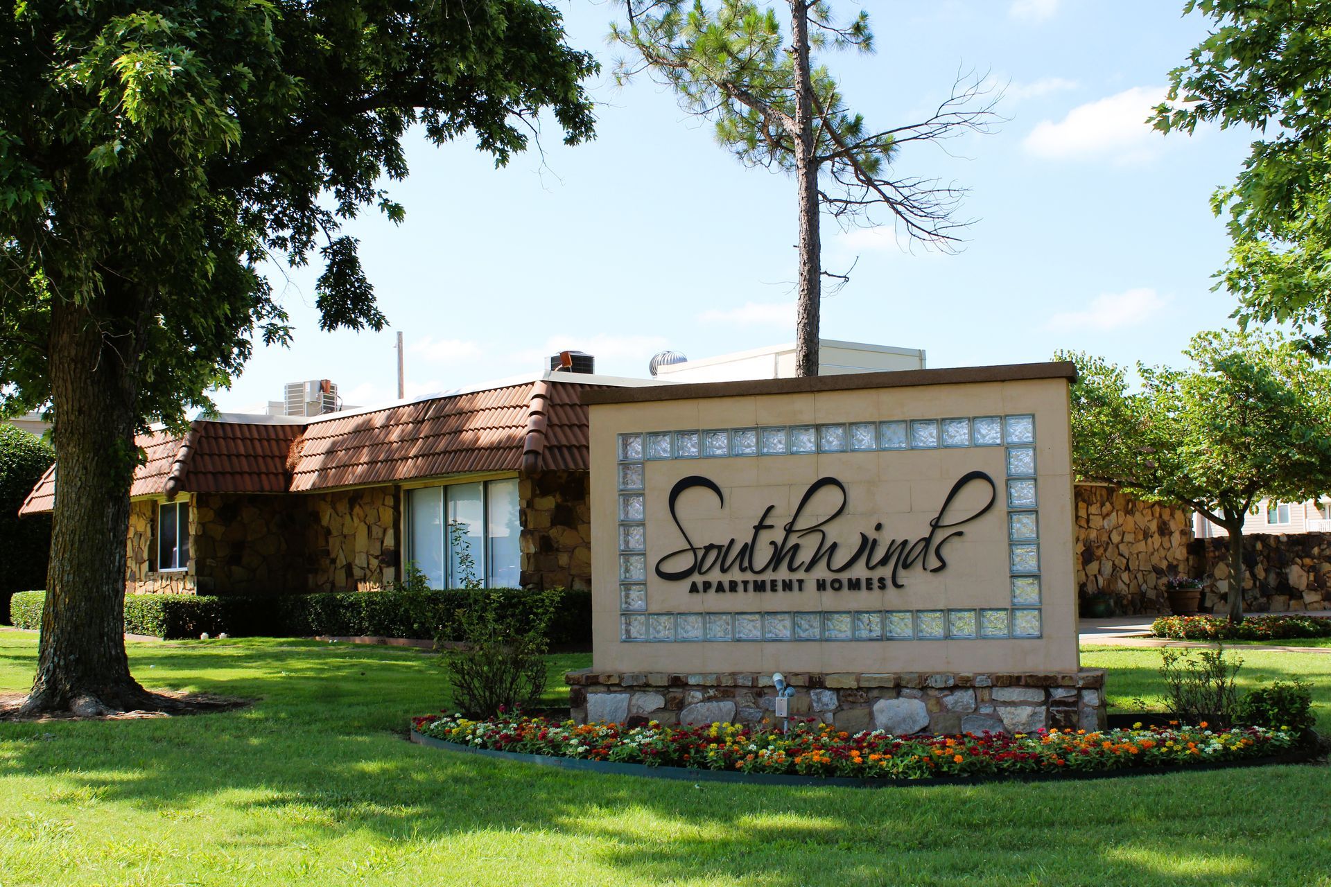 A sign for southwind apartment homes is in front of a house
