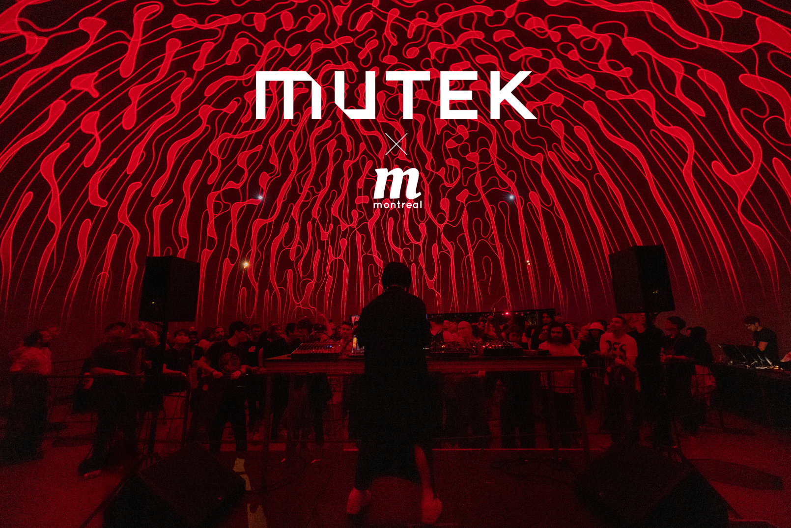 A man is standing in front of a stage with the word mutek on it.
