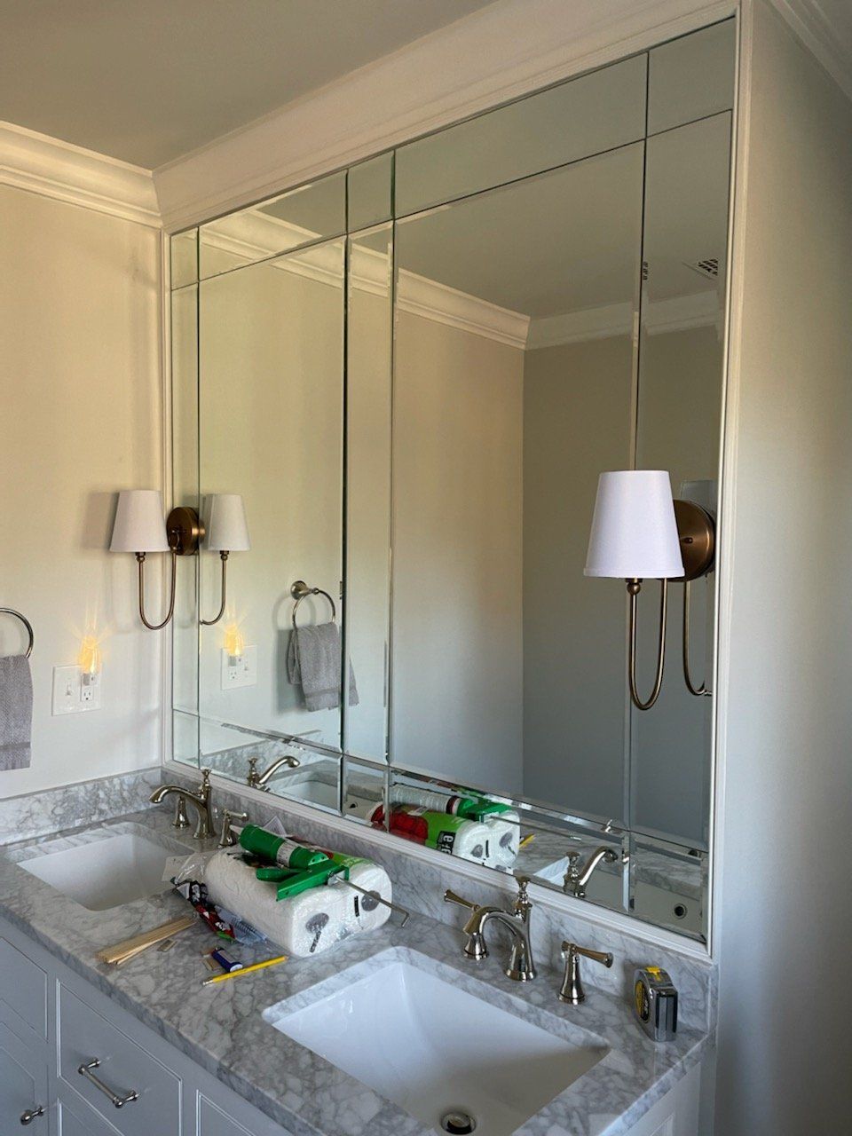 Bathroom with large, multi-panel mirror above a double vanity.