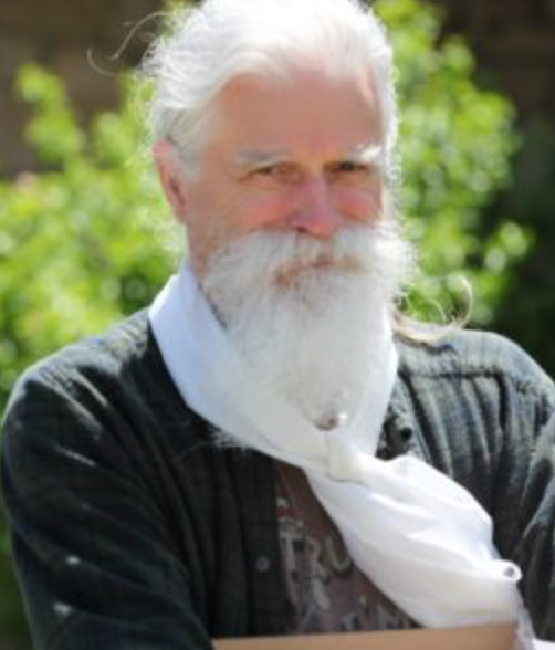 A man with a beard wearing a scarf around his neck