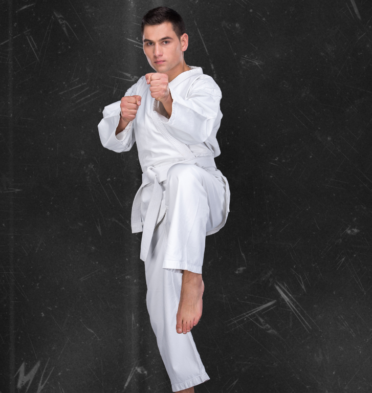 A man is wearing a white karate uniform with a black belt.