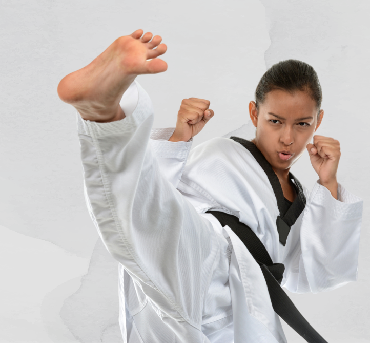 Two women are practicing karate in a dark room.