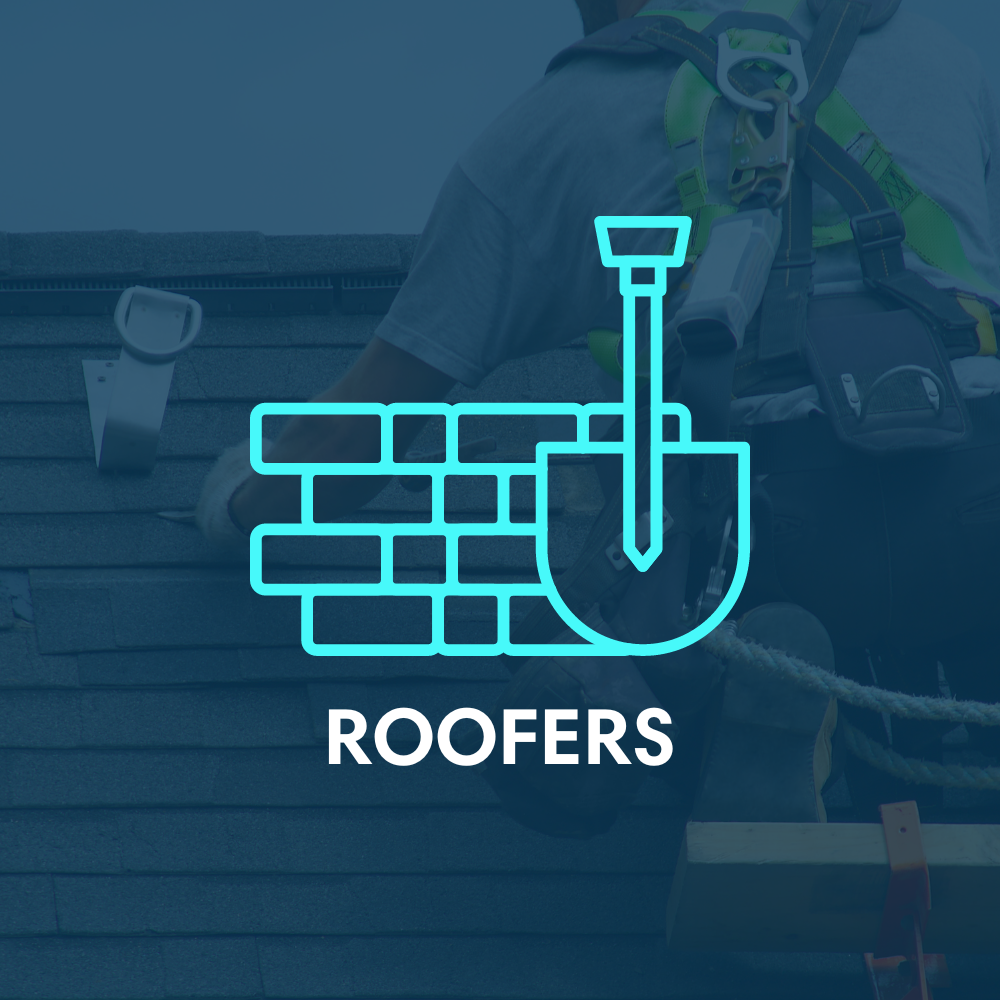 A man is sitting on a roof with a shovel in his hand.